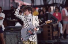 Chrissie Hynde holding an electric guitar waving her hand over her head