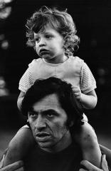 Bill Graham carrying a toddler on his shoulders