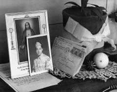a photo showing a framed image of Jesus Christ with a photo of a japanese man in military uniform and some letters in envelopes