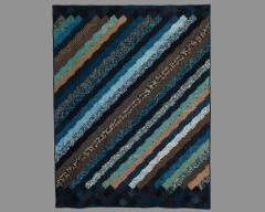 Diagonal stripped quilt in earth tone and blues.