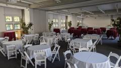 View of Haas reception room with middle divider pulled aside to show the full space filled with tables and chairs