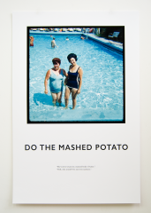 Two women wearing bathing suits stand in the shallow end of a pool