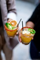 Cocktail glasses being held by two individuals