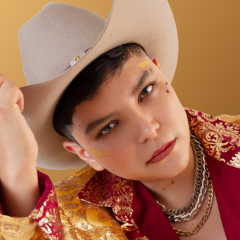 close up of a woman with short cropped hair and a tan cowboy hat