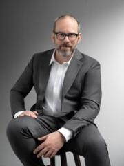 Dan Nadel sits on a stool facing the camera.