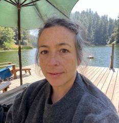 Vanessa Davis poses on a lake dock wearing a blue fuzzy sweater.