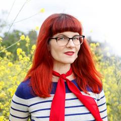 Allison Wolfe in front of yellow flowers.