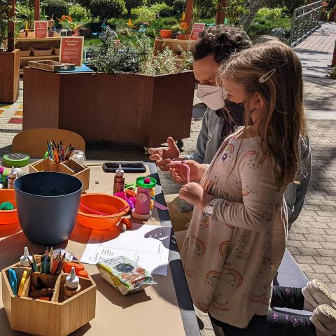 Photo of a family at a craft table outside at the Skirball