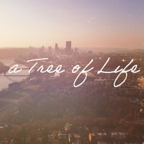 Ariel photo of the Pittsburg skyline with the words A Tree of Life in white script over it