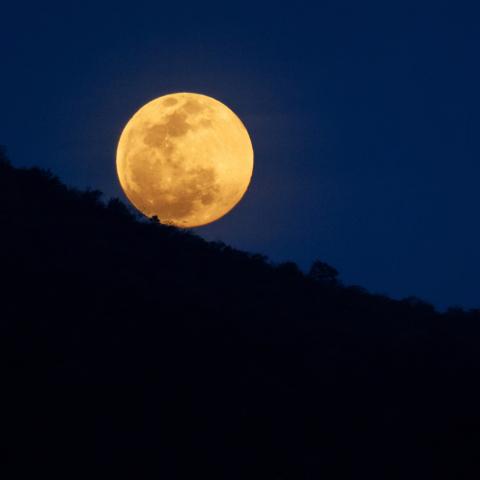 Full moon over the mountains.