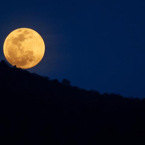 Full moon over the mountains.