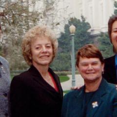 Photo of activists Carole Migden, Sheila Kuehl, Jackie Goldberg, and Christine Kehoe standing together in a green park