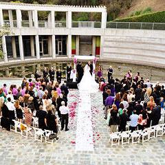 Wedding ceremony at Skirball in courtyard by a pond