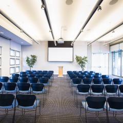Haas Conference Center showing chair arranged in rows facing a projection screen