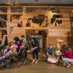 families playing in front of Noah's Ark