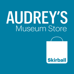 Audrey's Museum Store logo typeface with shopping bag icon in white on blue background