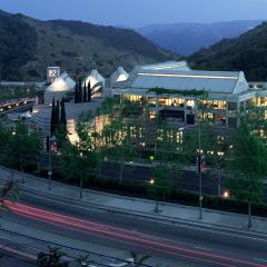 Skirball campus at night from across the street with a long exposure showing traffic on the road