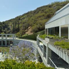 Image of Taper courtyard with visitors looking at the lily pond and mountains in the background