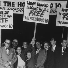 A black and white photo of a group of protesters with signs that read, "Free the Hollywood 10"