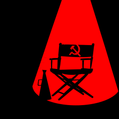 An illustration of a  black background with a red spotlight. In the red spotlight is a director's chair with a hammer and sickle symbol on the chair back. A megaphone sits next to the chair.