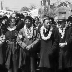 Martin Luther King Jr among other protester in a line.