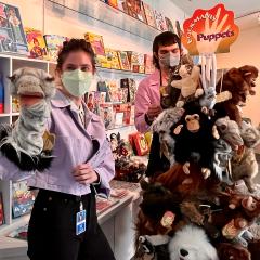 Two staff members with animal puppets in the Noahs Ark Store