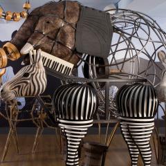 Sculptures of an elephant, two zebra, and a deer made of everyday materials including a keyboard for a zebras mane and floor matts for the elephants ears. 