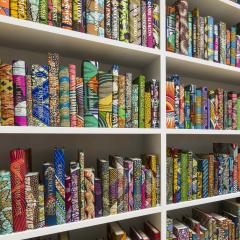 Close up view of colorful books on white shelves