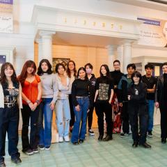 A group of students stands in the Visions & Values gallery.
