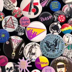 Various wearable colorful buttons with text and bands on them.