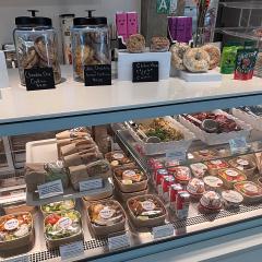 Shelves with fresh salads and sandwiches and other snacks.